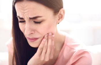 woman with tooth pain, Lawrenceville, GA