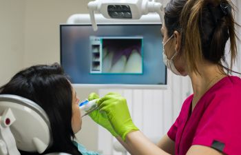 Dentist performing oral screening.