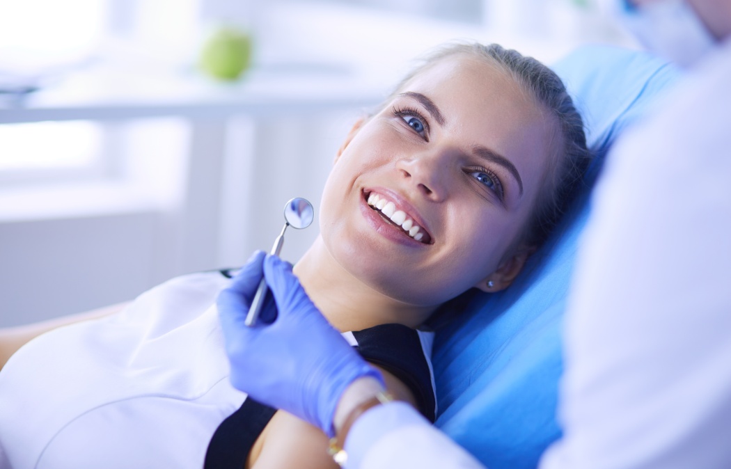 Young Female patient with pretty smile examining dental inspection at dentist office. Coronavirus COVID-19 virus pandemic, Lawrenceville, GA