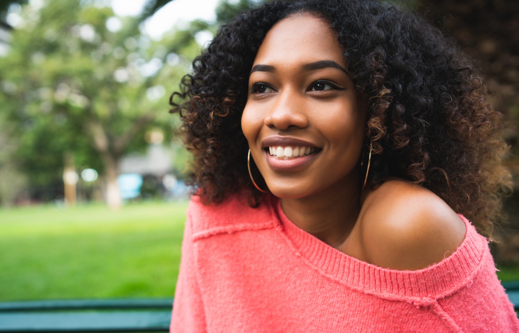Portrait of young beautiful afro american woman sitting on bench in the park. Outdoors., Lawrenceville, GA